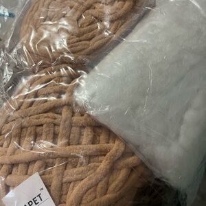 5 opened skeins of chenille yarn with all of the tools you need to sew with